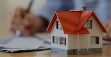 Miniature house with paperwork
